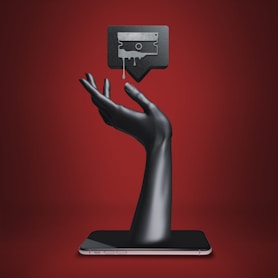 a hand holding a tablet with a tv on top of it