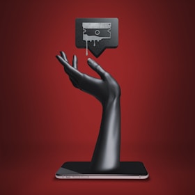 a hand holding a tablet with a tv on top of it