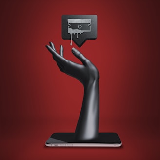 a hand holding a tablet with a tv on top of it