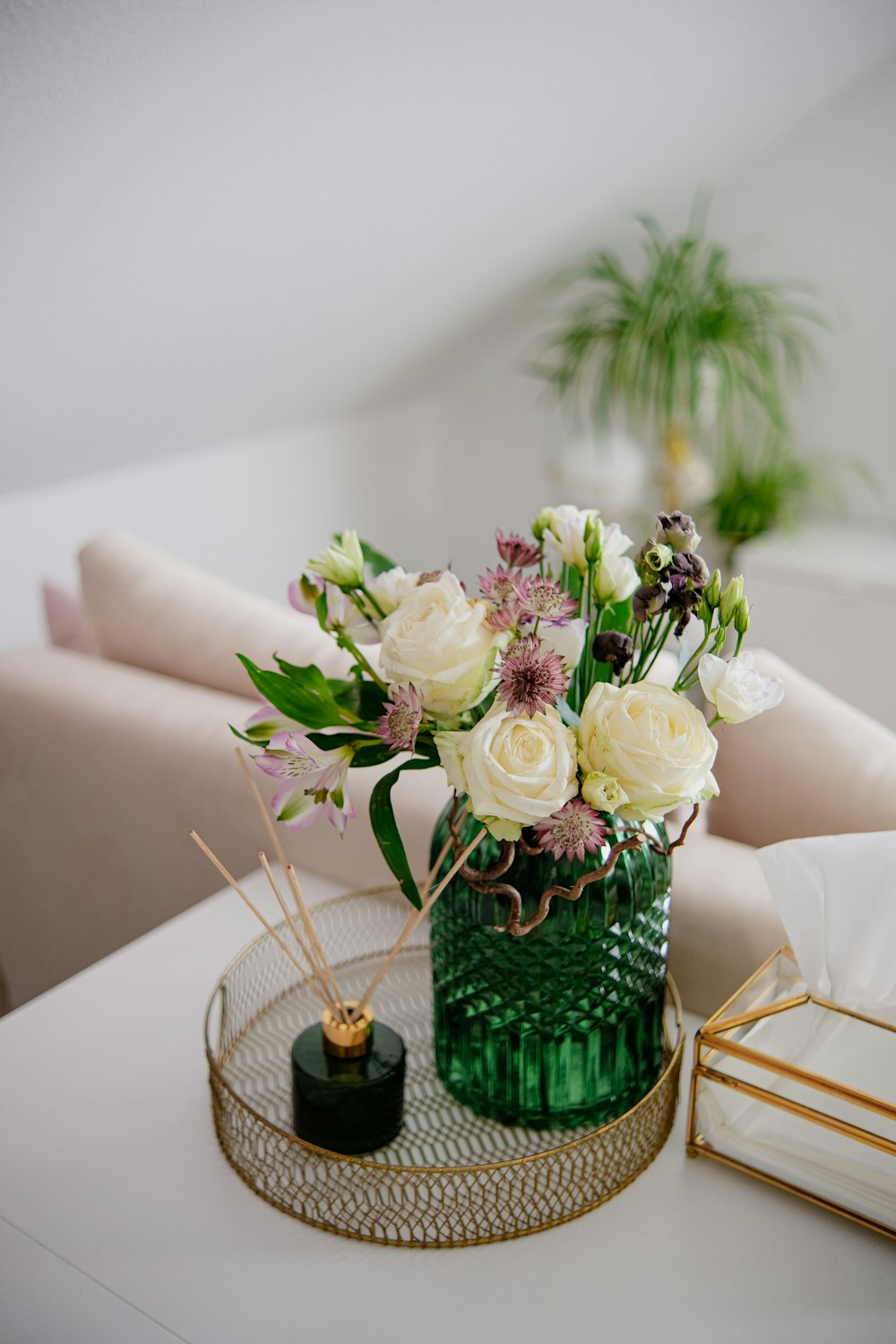 a vase of flowers on a tray on a table