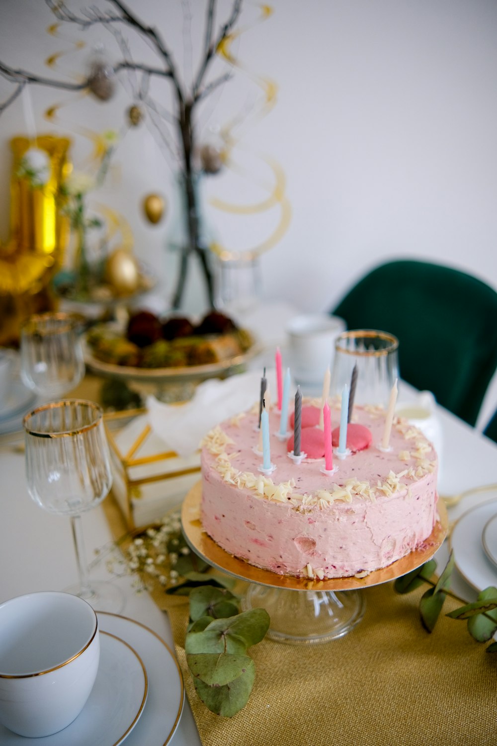 a pink cake sitting on top of a table