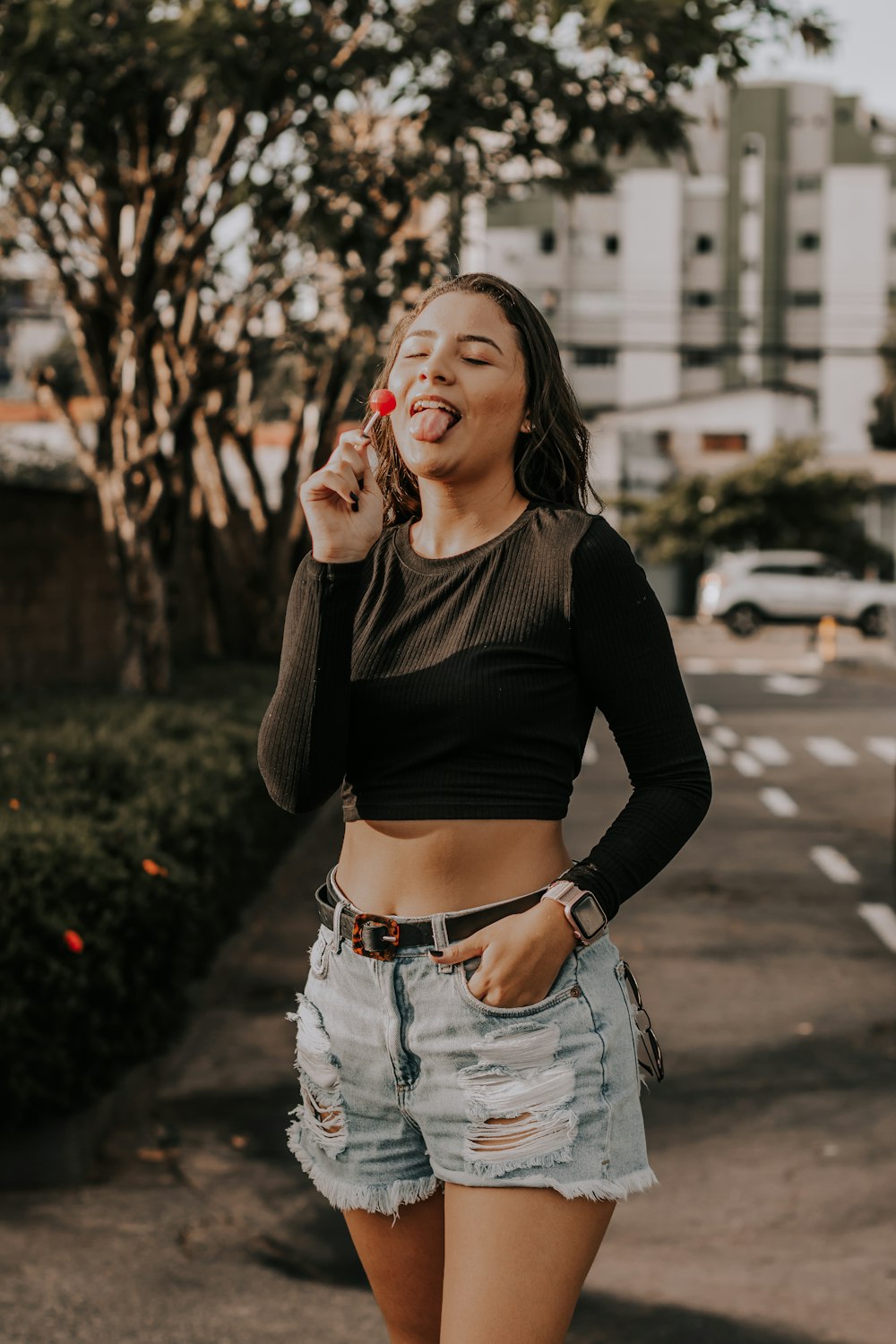 a woman standing on a street with her mouth open