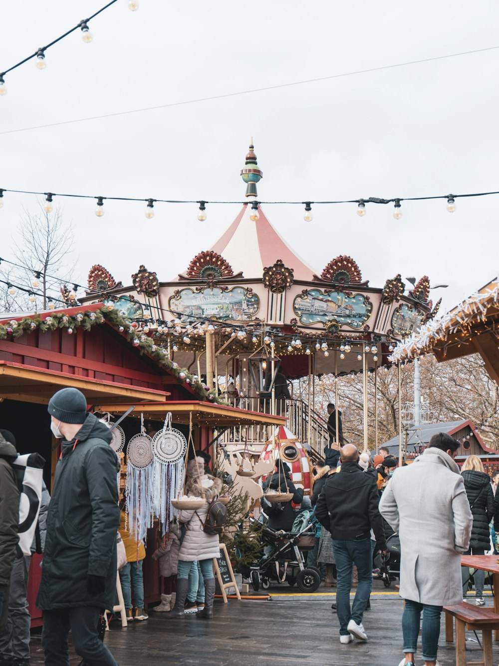 a group of people standing around a merry go round