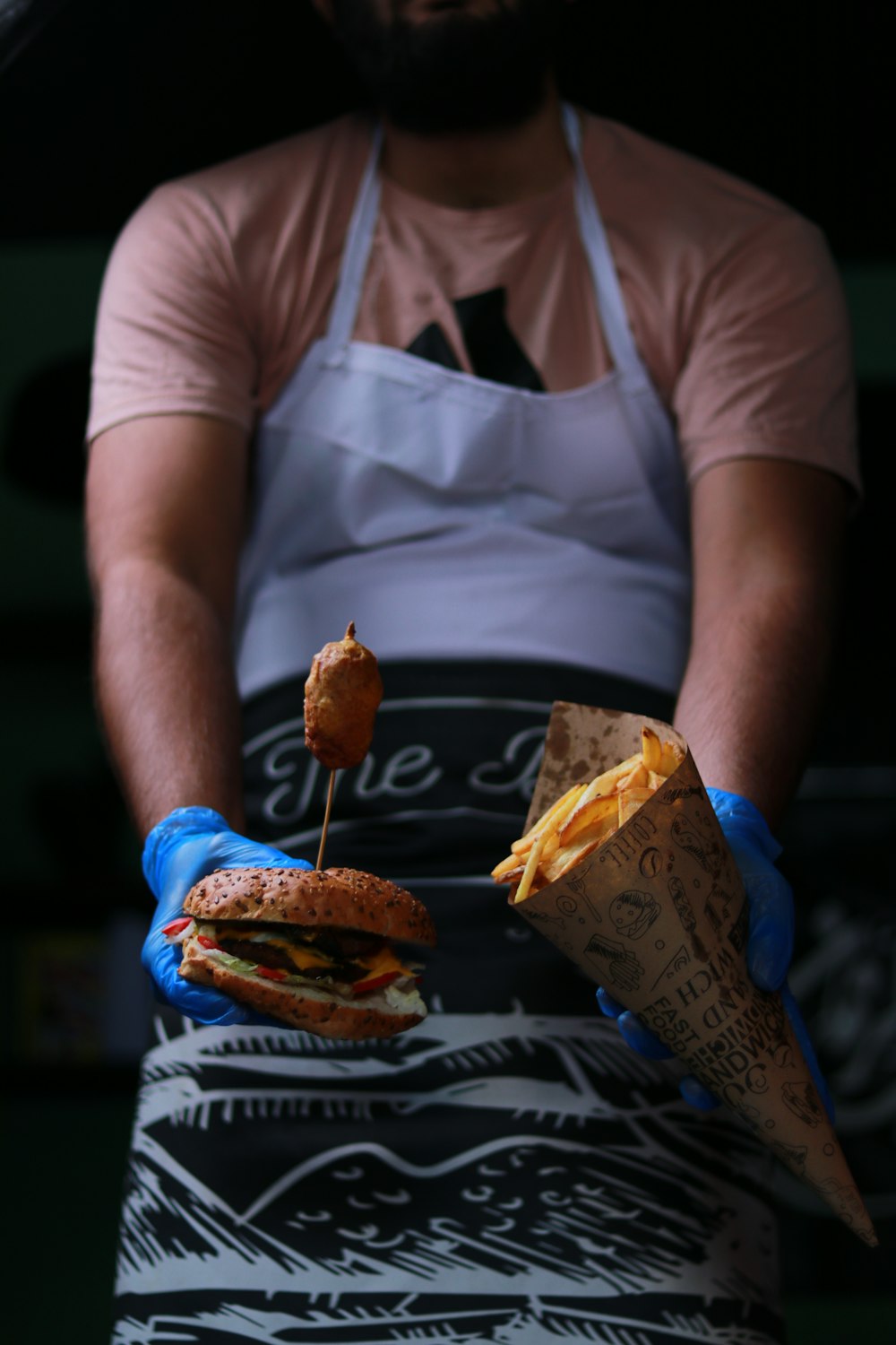 a man holding a piece of cake on a table