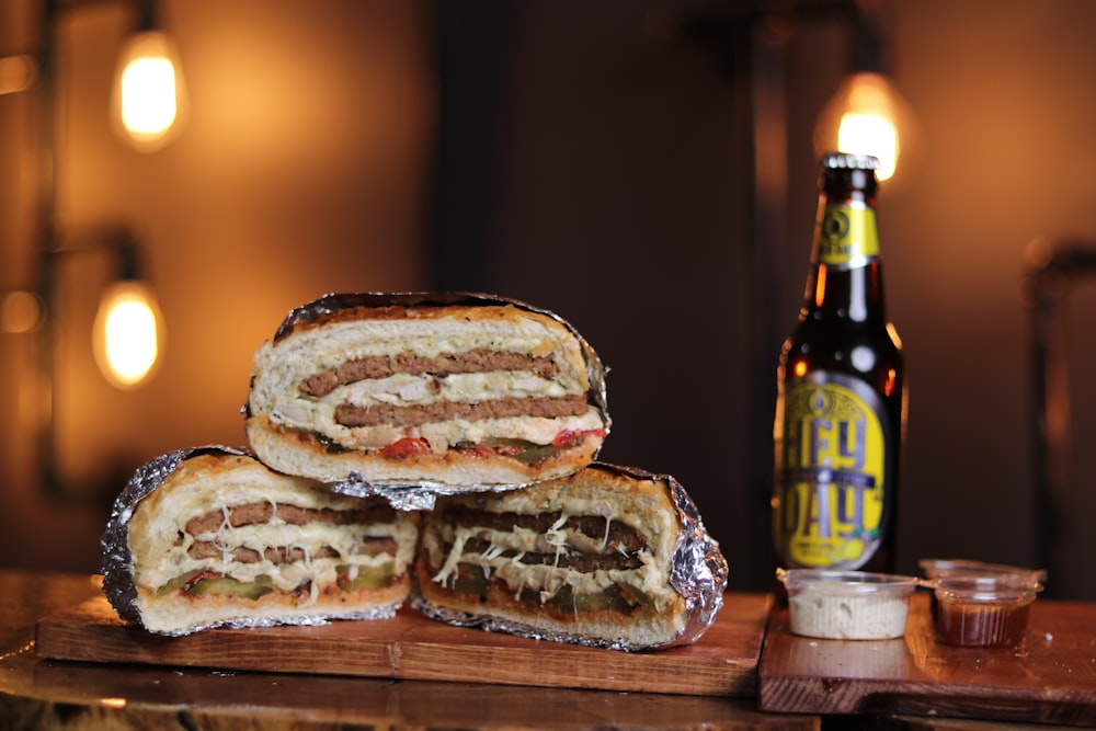 a sandwich cut in half sitting on top of a cutting board