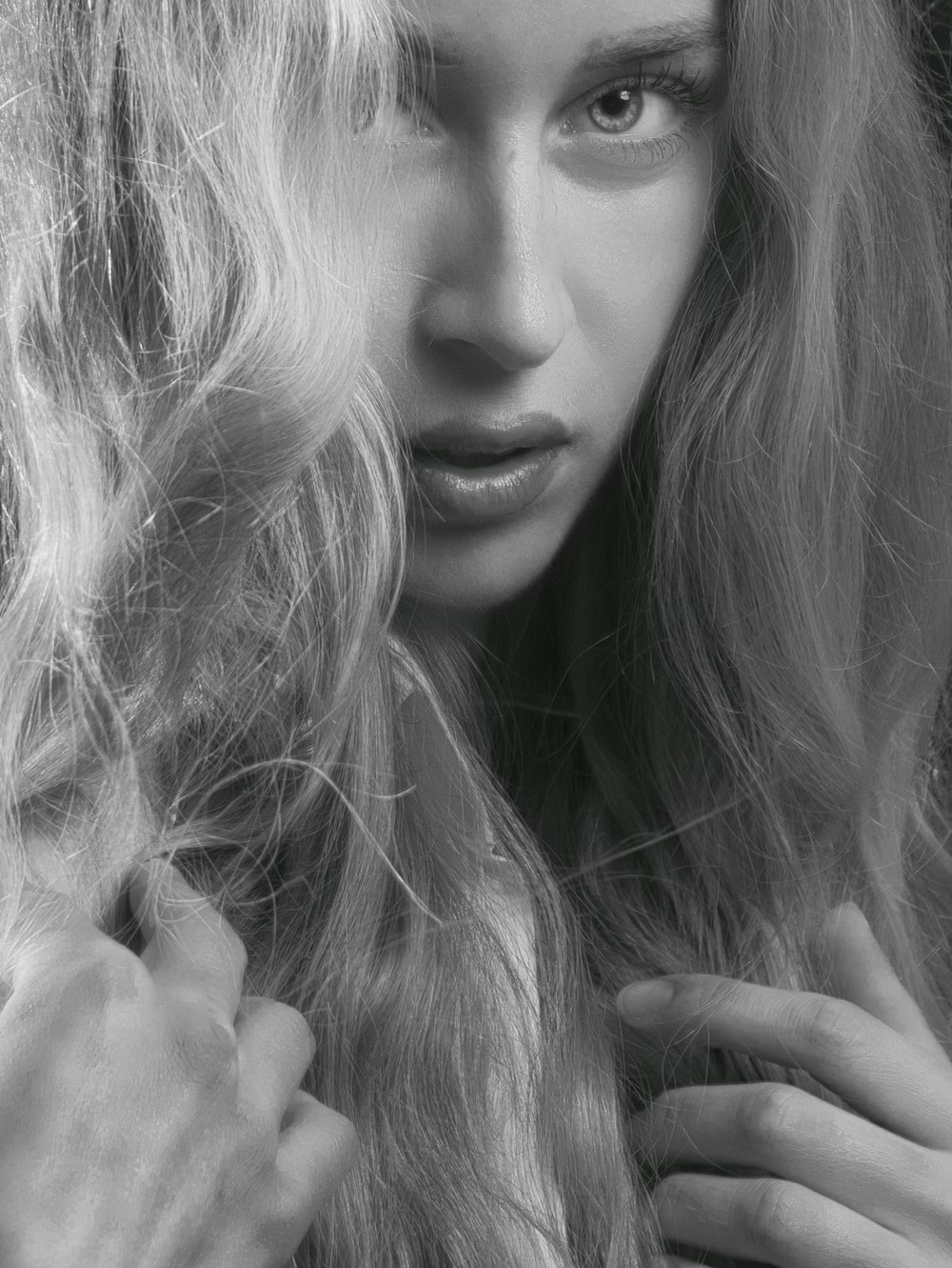 a black and white photo of a woman with long hair