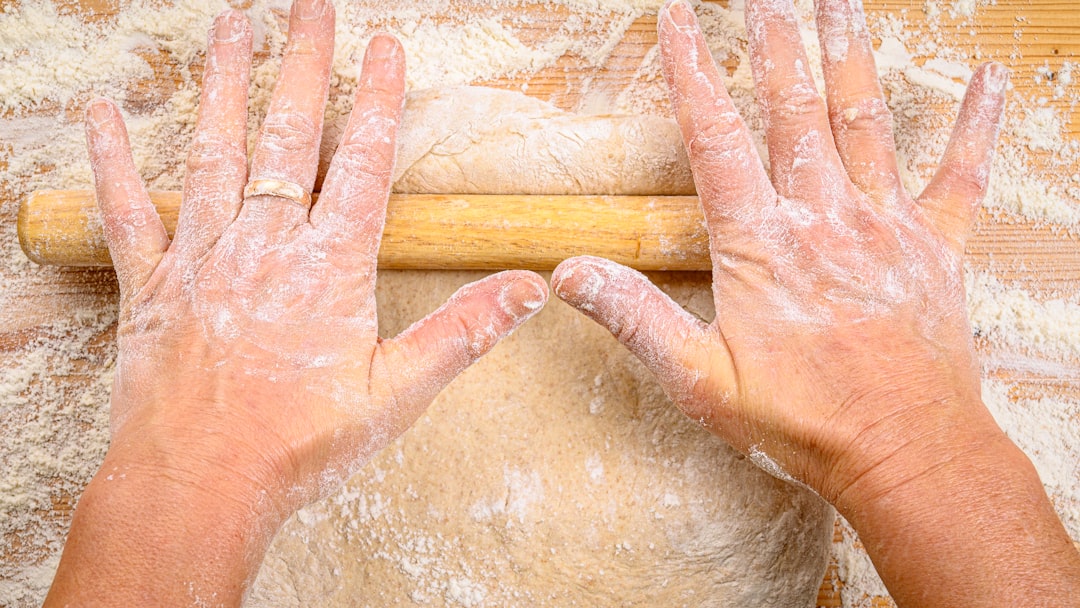a person with their hands on a rolling pin