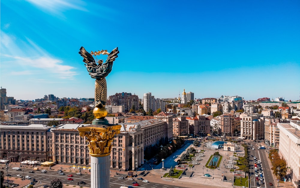 a view of a city with a statue in the middle