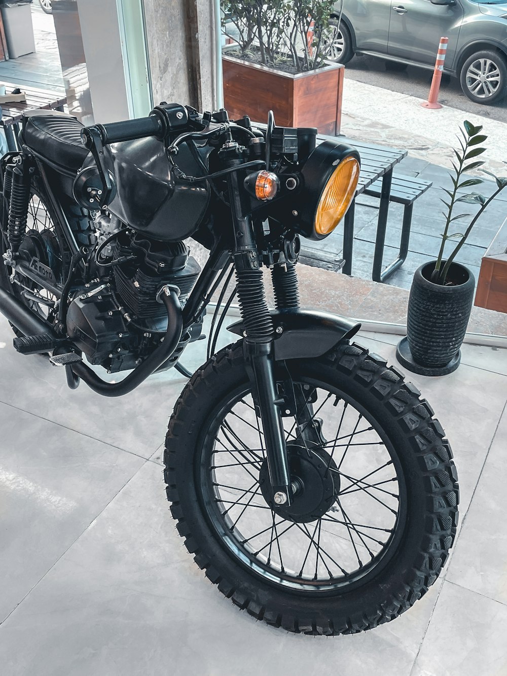 a black motorcycle parked in front of a building