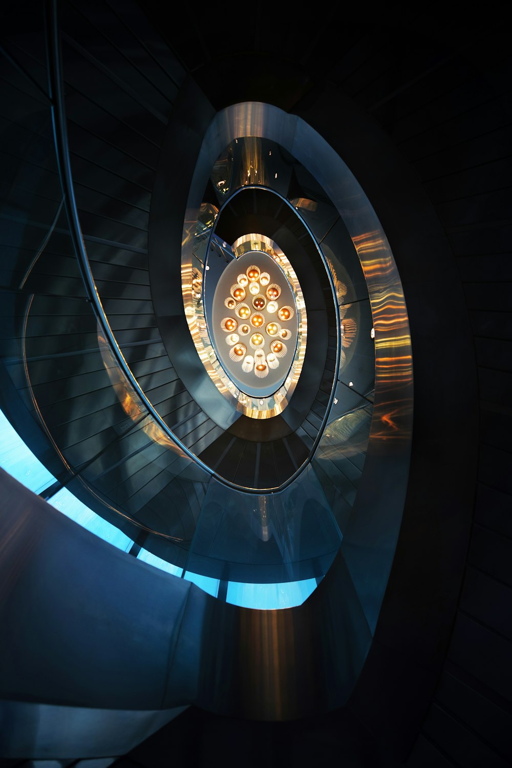 a spiral staircase in a building with lights on