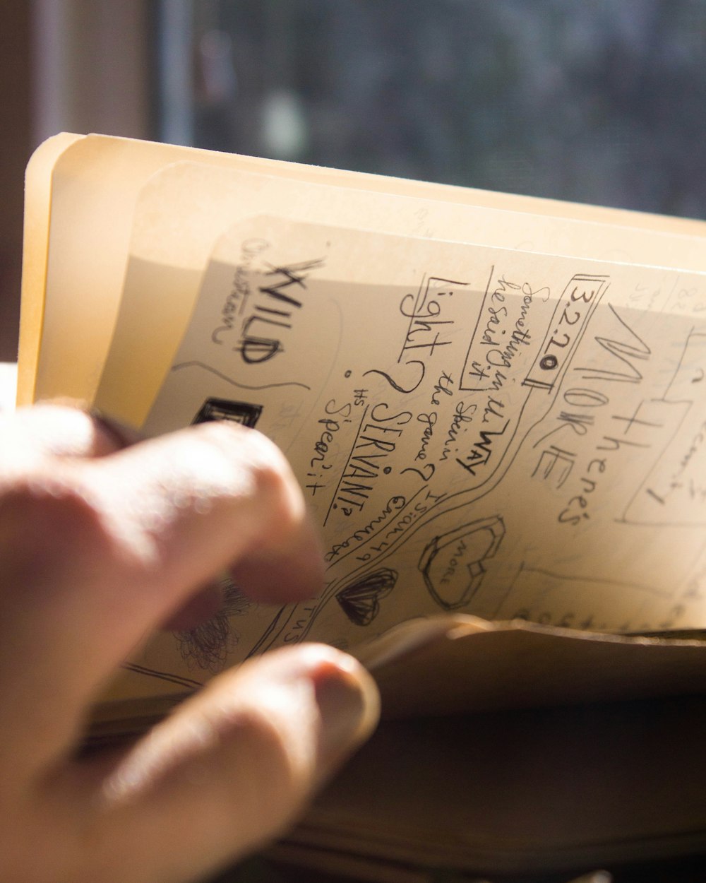 a person holding a book with writing on it