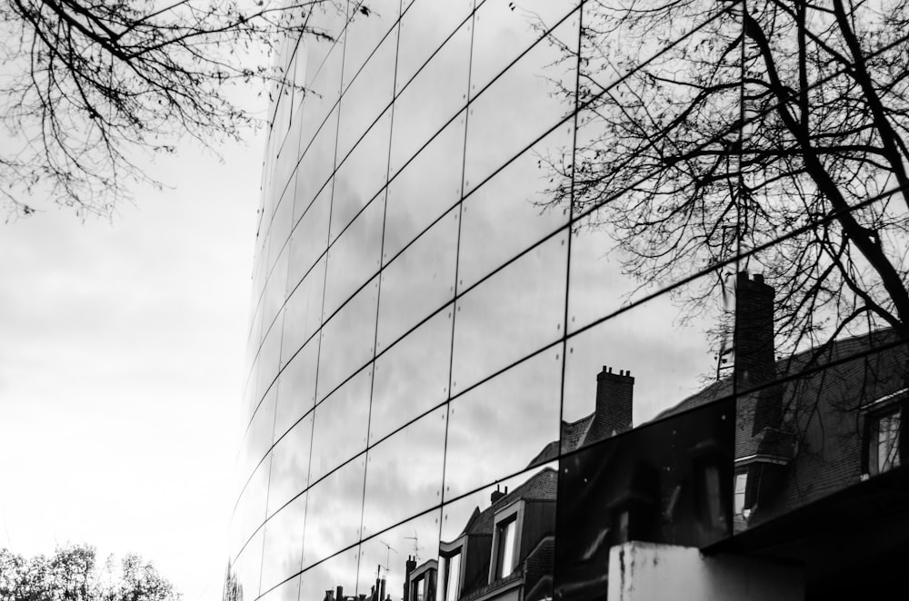 a black and white photo of a building and trees