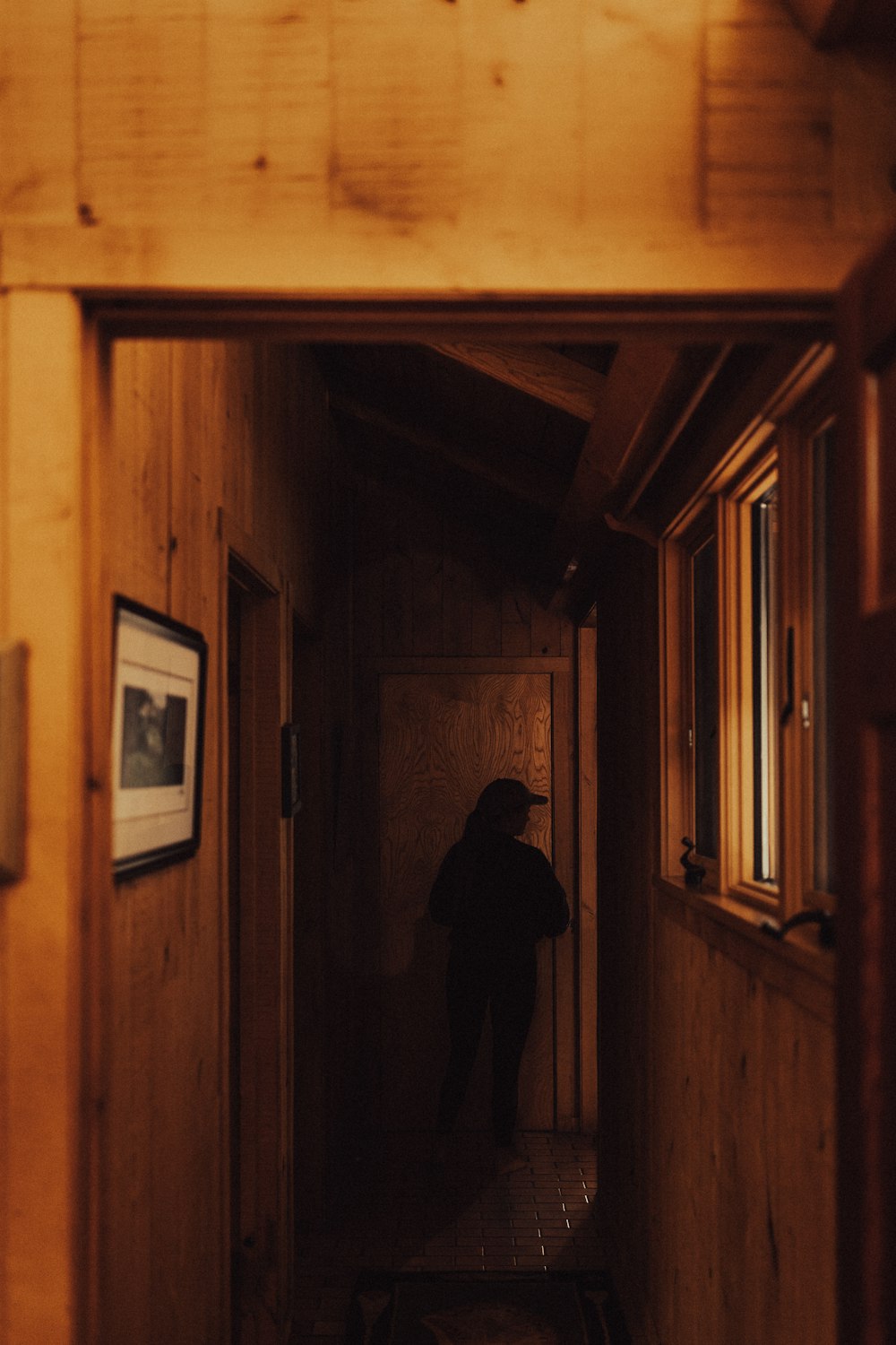 a person standing in the doorway of a cabin