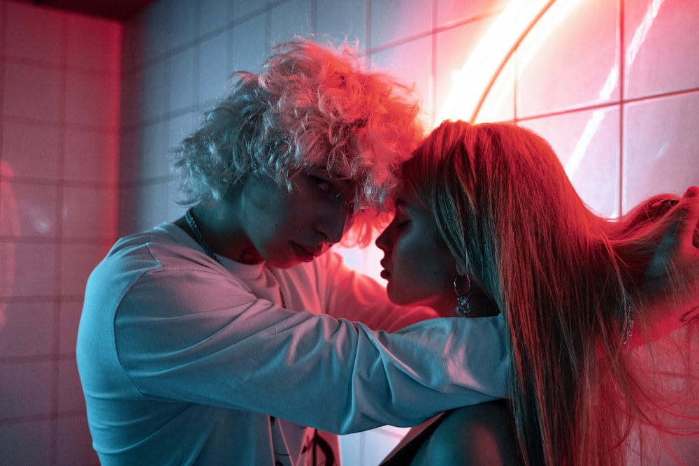 a man and a woman standing next to each other in a bathroom