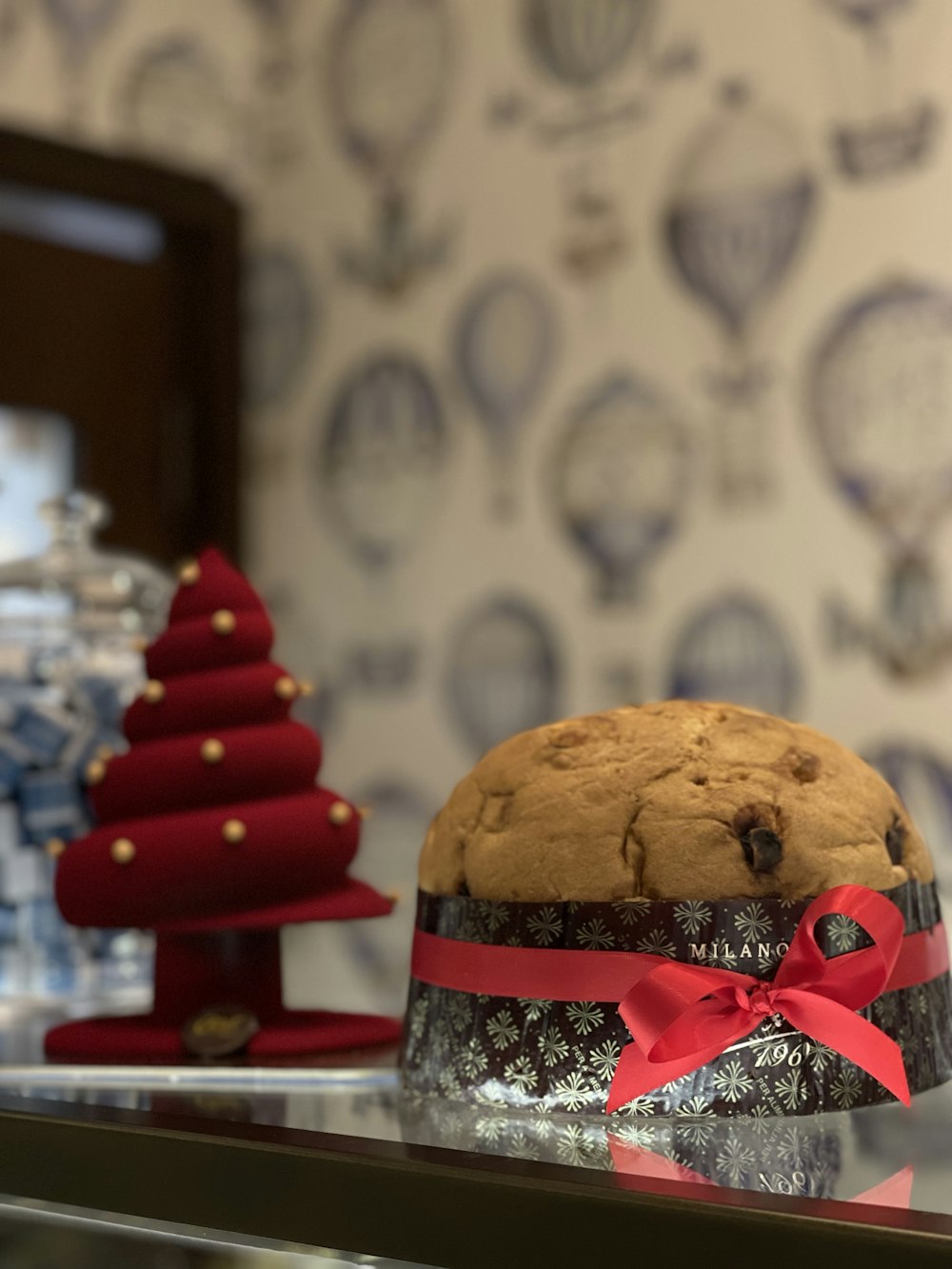 a cake sitting on top of a counter next to a christmas tree