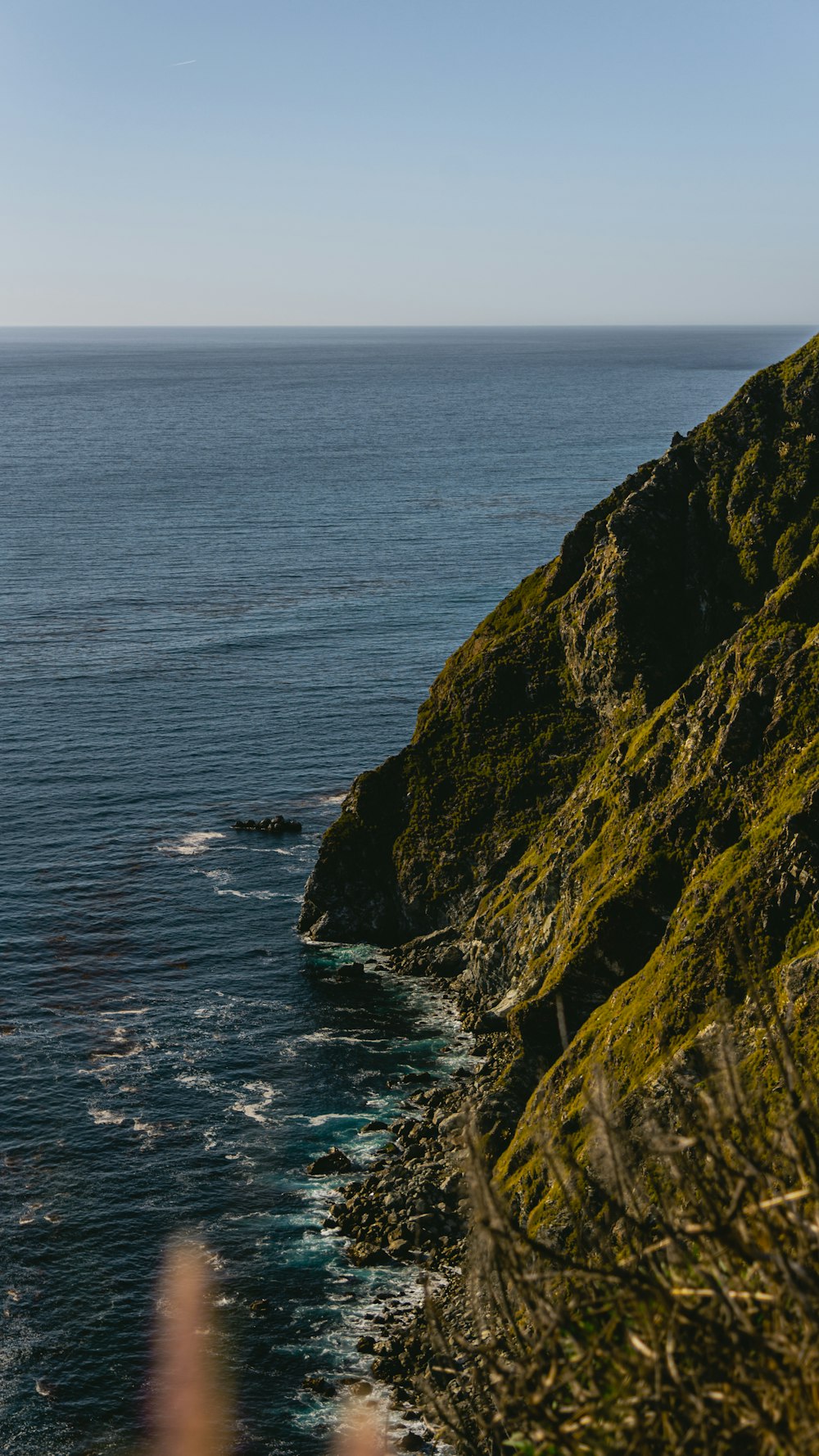 a person standing on a cliff overlooking the ocean