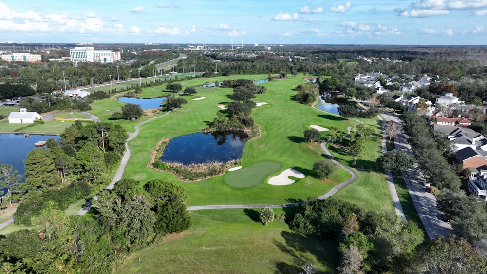 an aerial view of a golf course surrounded by trees