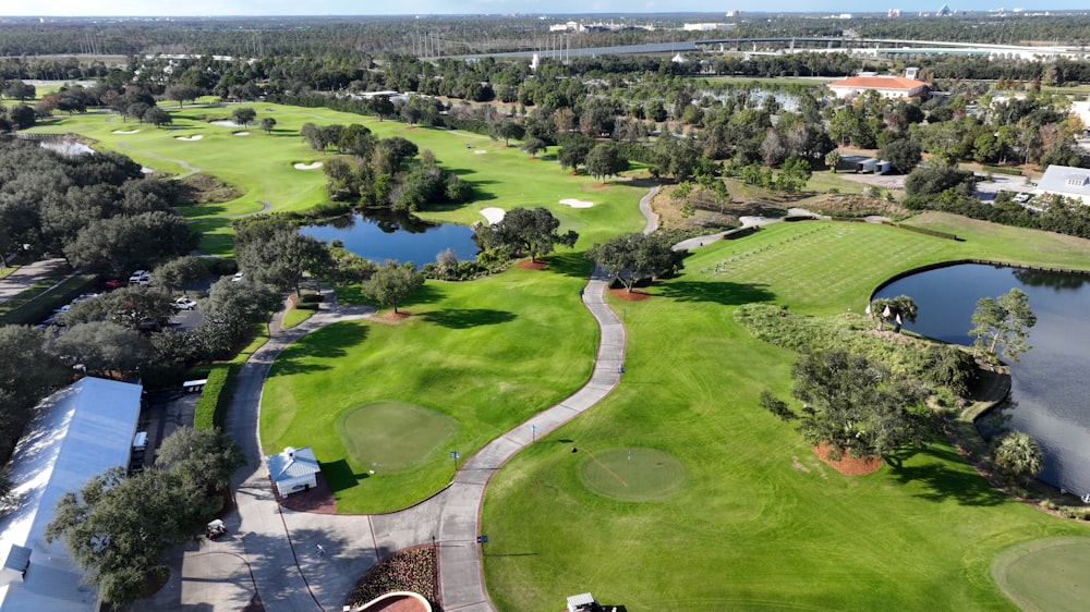 an aerial view of a golf course surrounded by trees