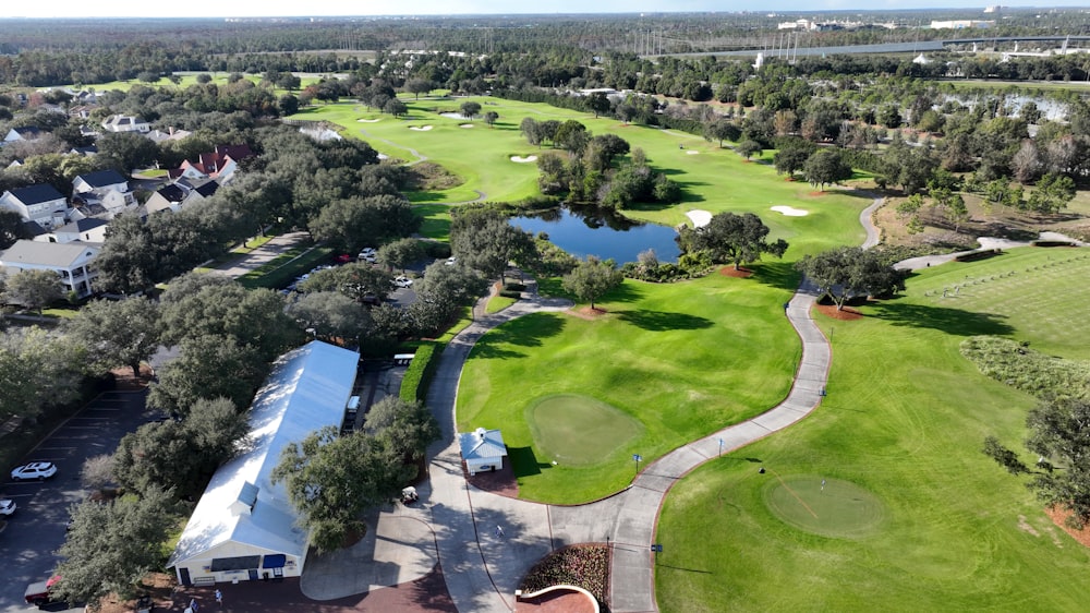 an aerial view of a golf course surrounded by trees