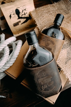 a couple of bottles of liquor sitting on top of a wooden table