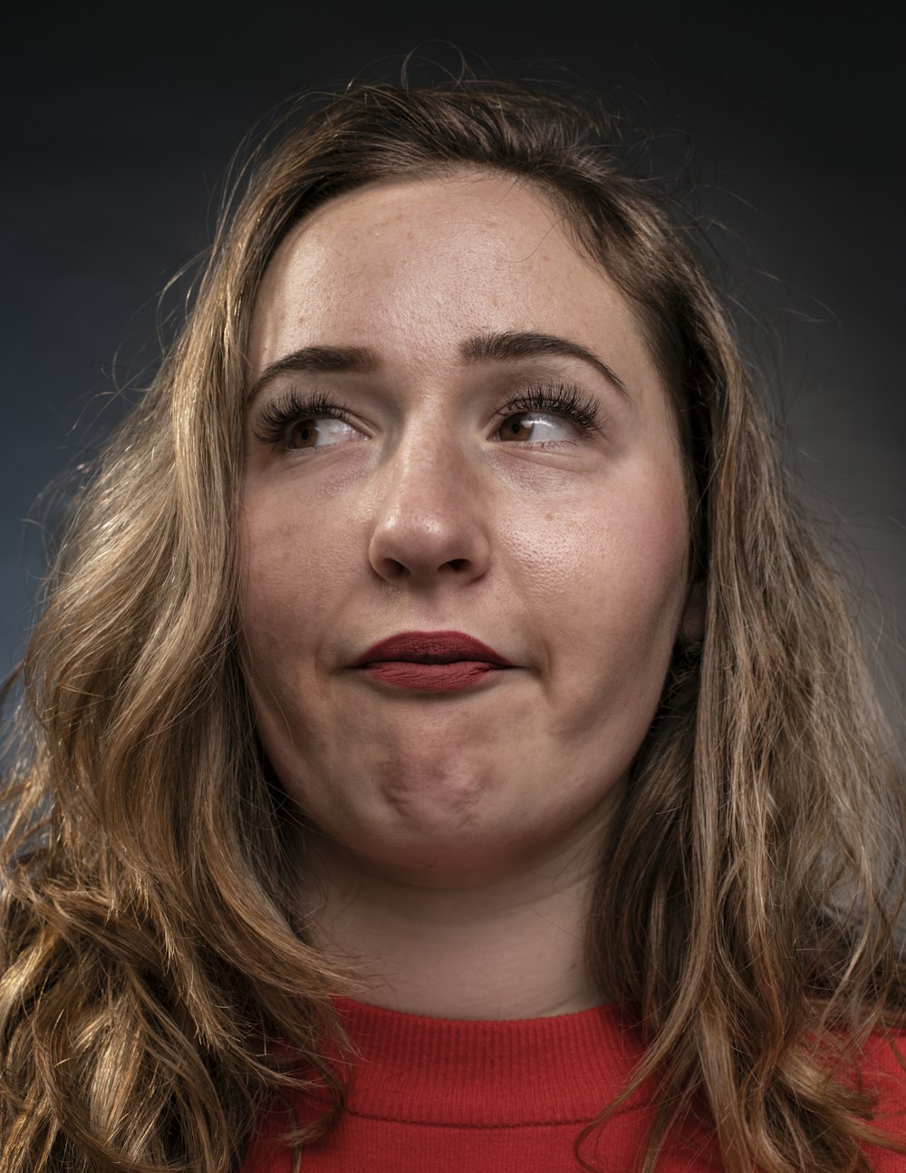 a close up of a person wearing a red shirt