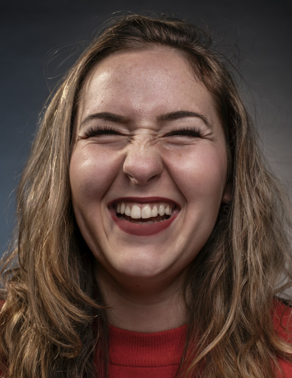 a woman smiling with a toothbrush in her mouth