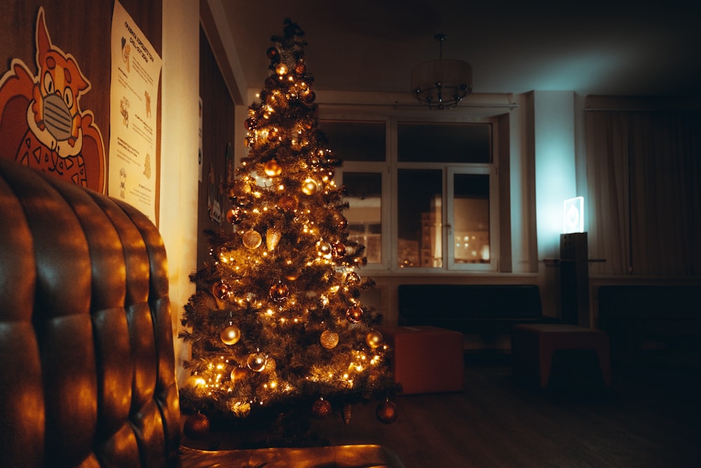 a lit up christmas tree in a living room
