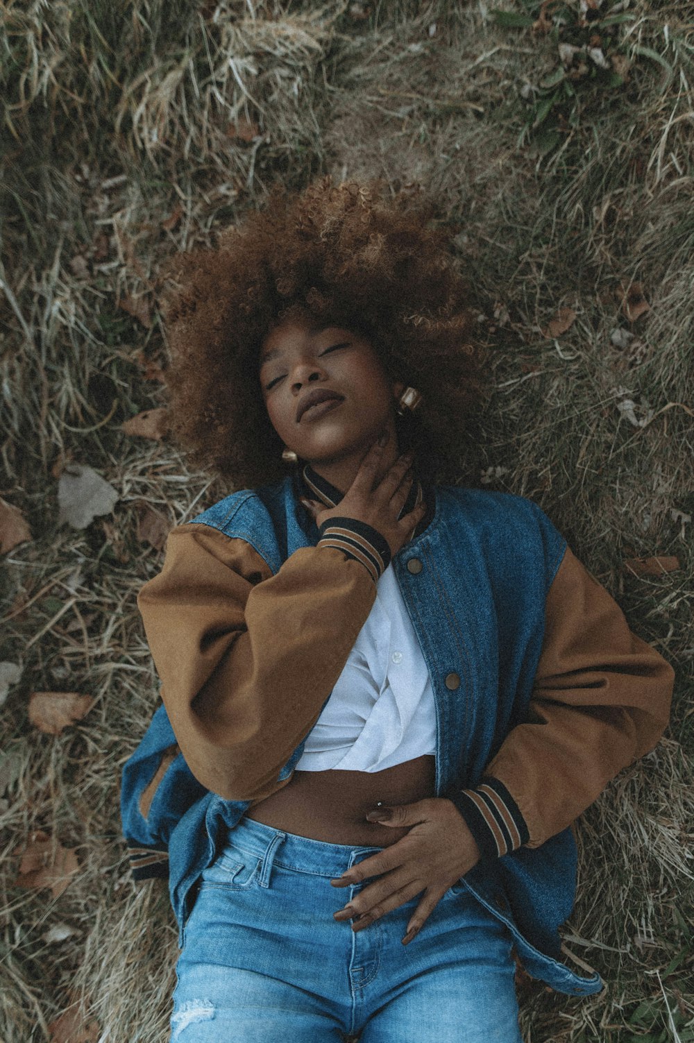 a woman laying on the ground with her head on her hands