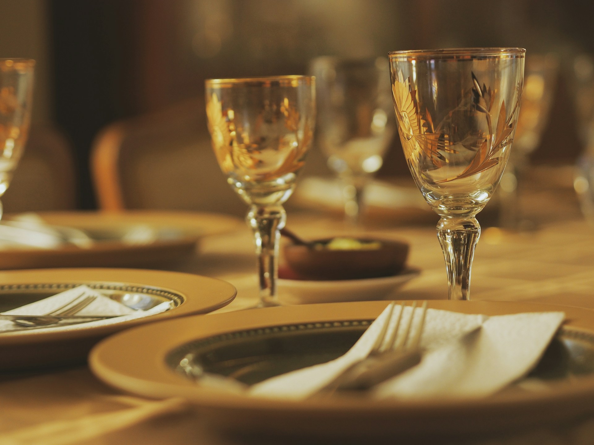 a close up of a table with glasses and plates