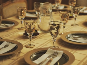 a table set for a formal dinner with place settings