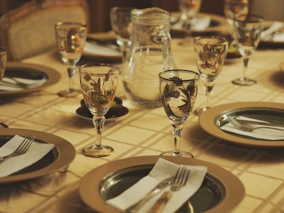 a table set for a formal dinner with place settings