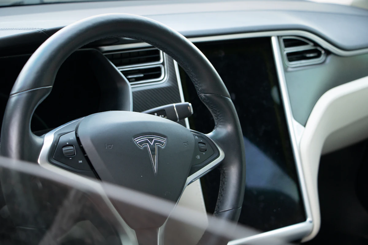 A Tesla steering wheel and dashboard seen up close