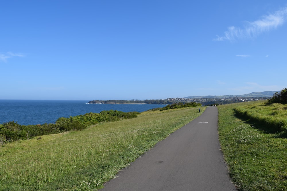 a paved road with a view of the ocean