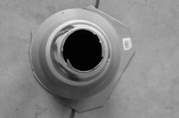 Stainless steel E-type retaining ring installed on a mechanical shaft, showing its secure fit.