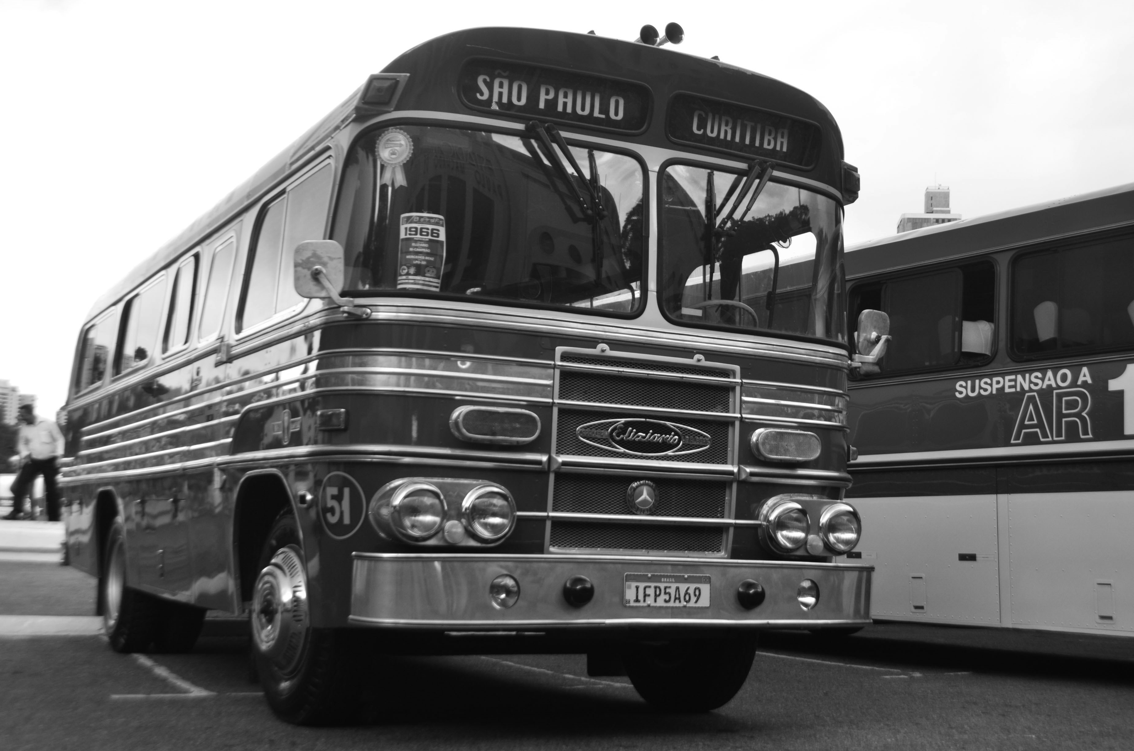 a black and white photo of two buses