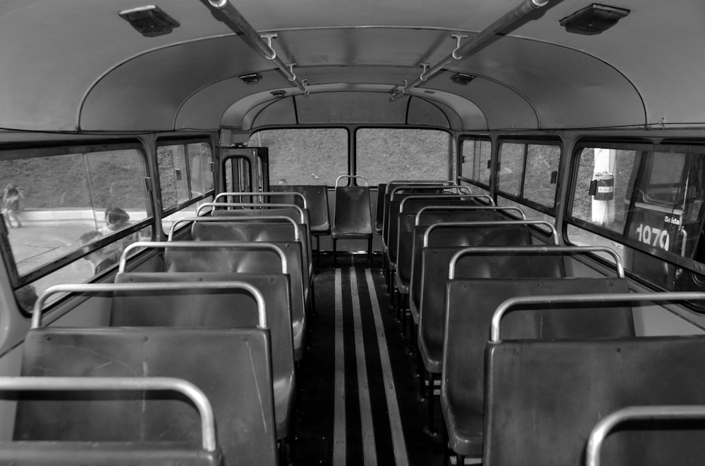 a black and white photo of a bus interior