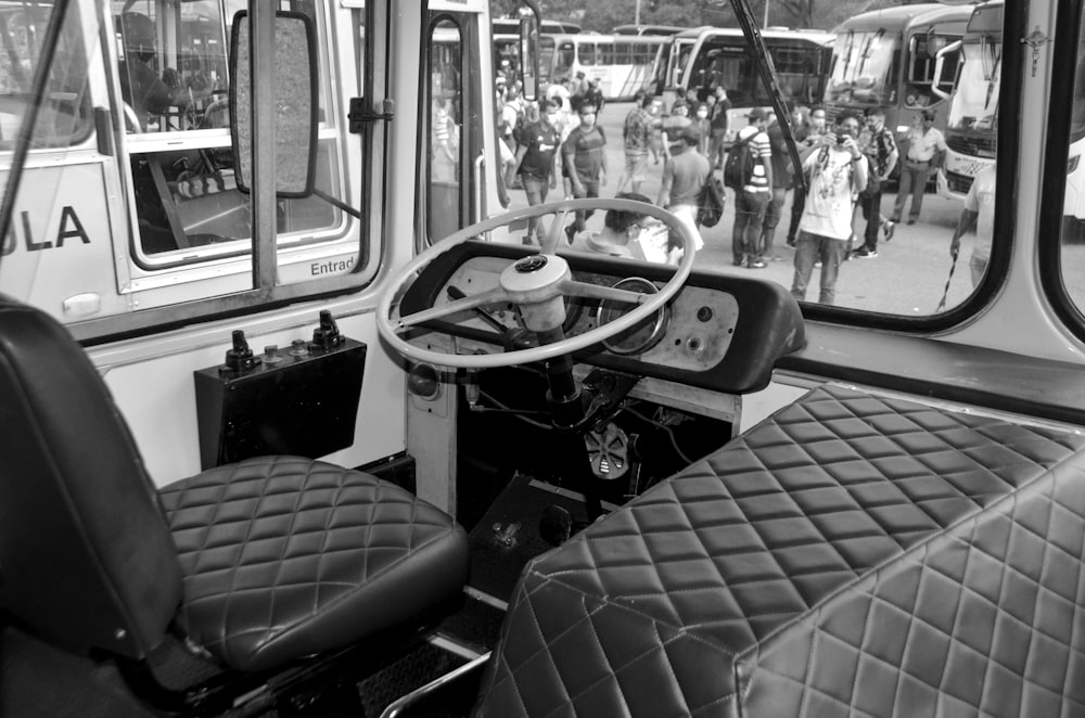 a black and white photo of a bus interior