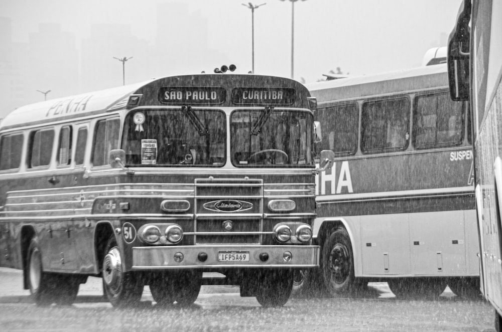 a black and white photo of a bus and a bus