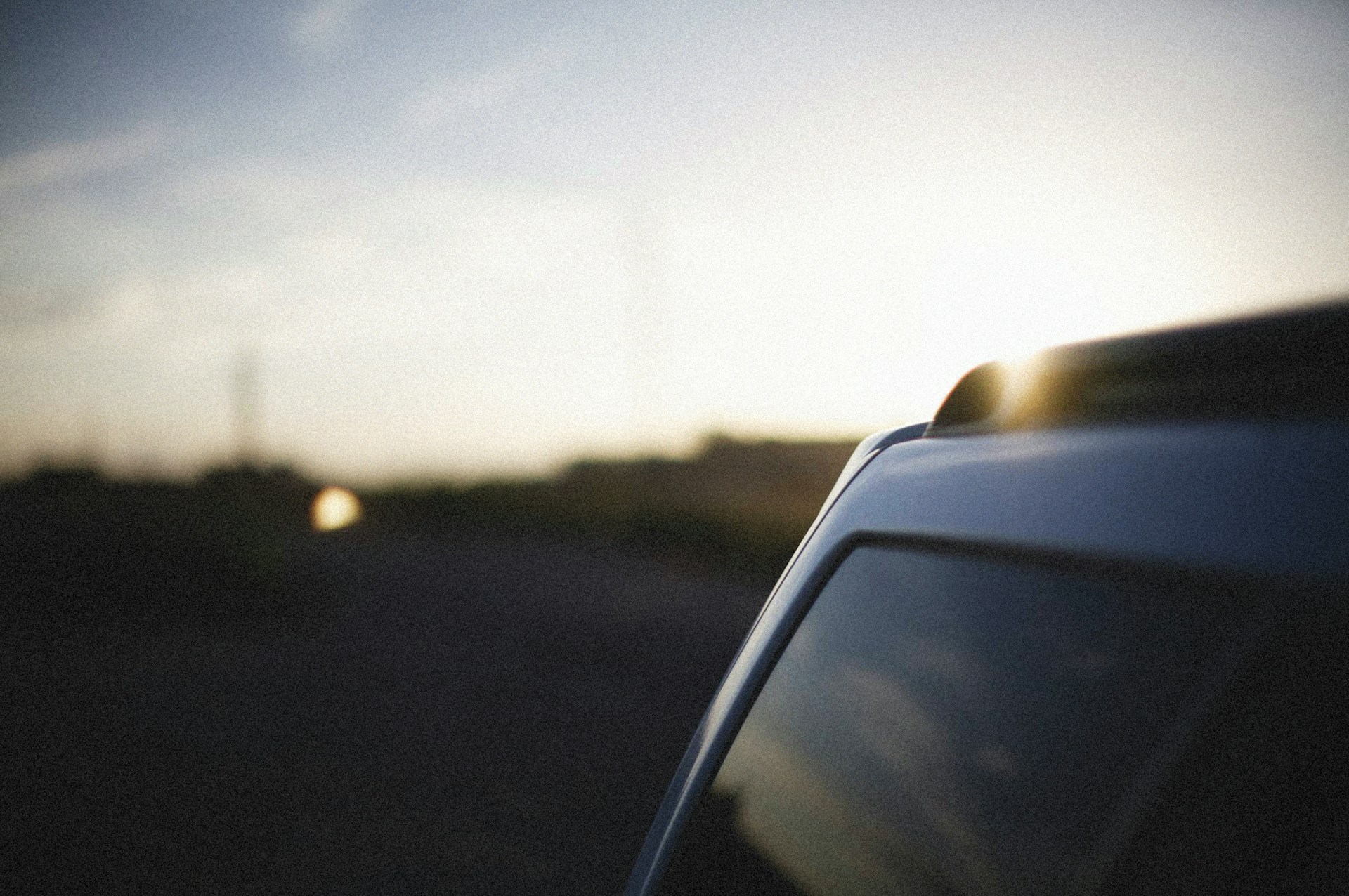 the sun shines brightly through the windshield of a car