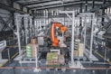 a factory with a robot in the middle of it