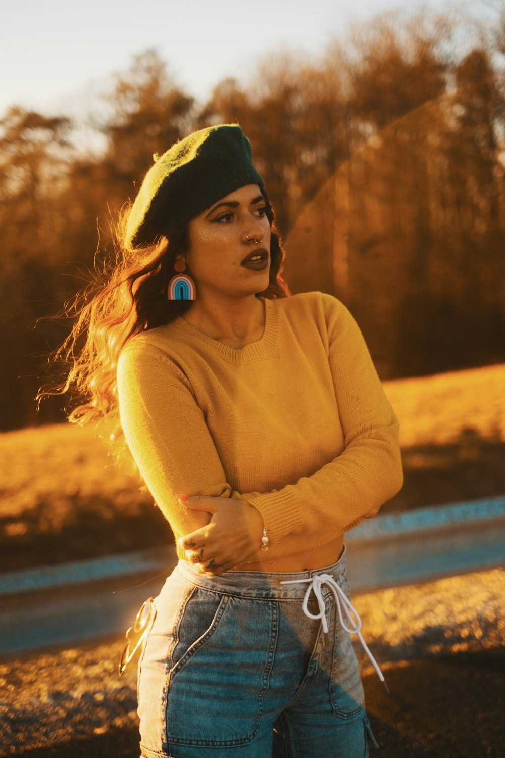 a woman wearing a yellow sweater and a green hat