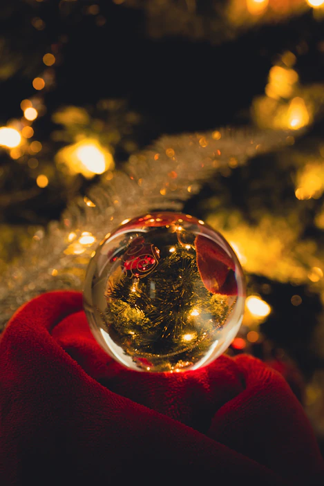 a glass ball sitting on top of a red blanket