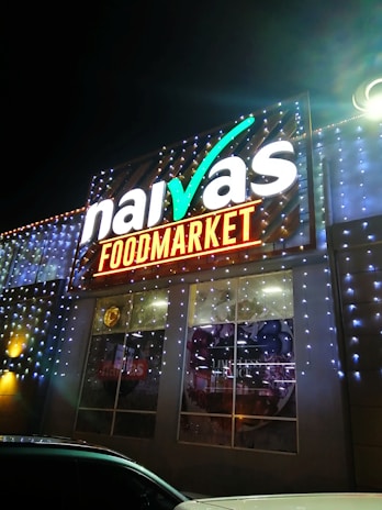 A vibrant food brand logo showcased on a shop signboard with electric blue accents.