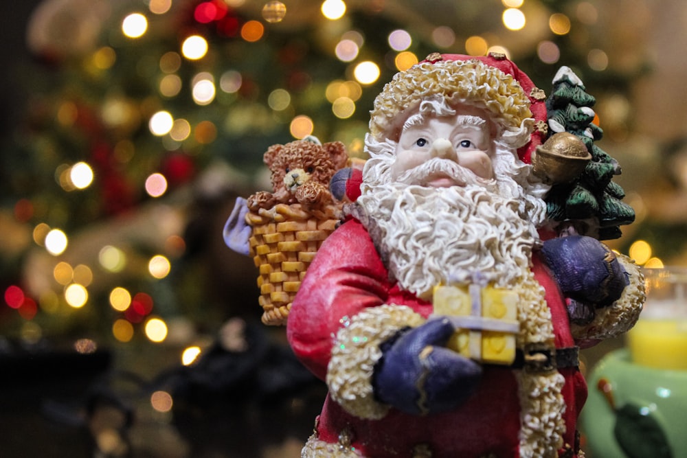 a santa clause figurine holding a basket of presents