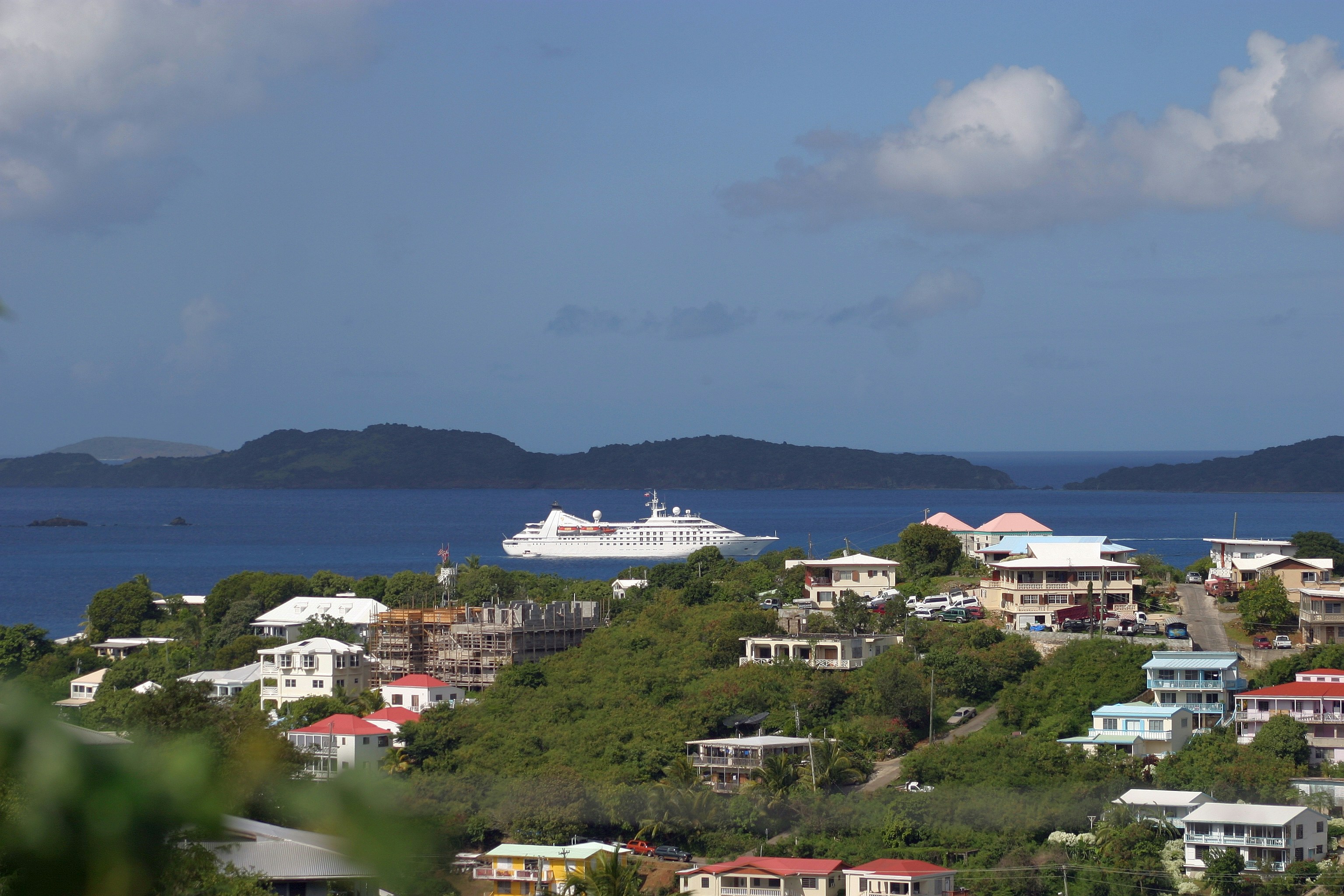 a cruise ship is in the distance on the water, 