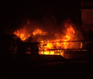 a fire blazing in a building at night