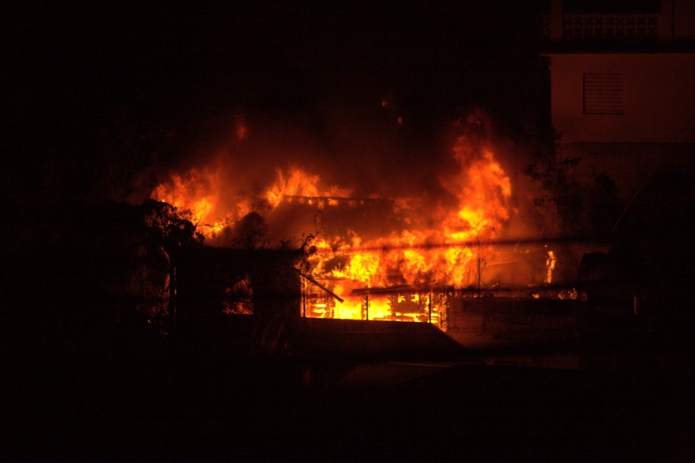 a fire blazing in a building at night