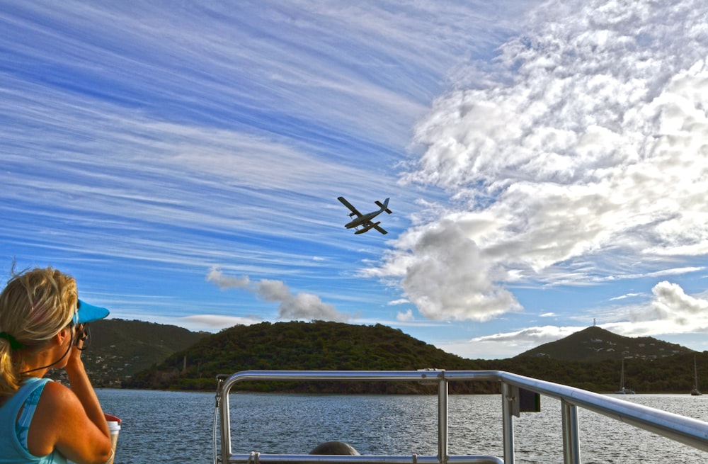 a small plane flying over a body of water