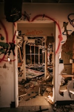 a run down room with graffiti all over the walls
