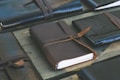 a leather bound notebook sitting on top of a wooden table